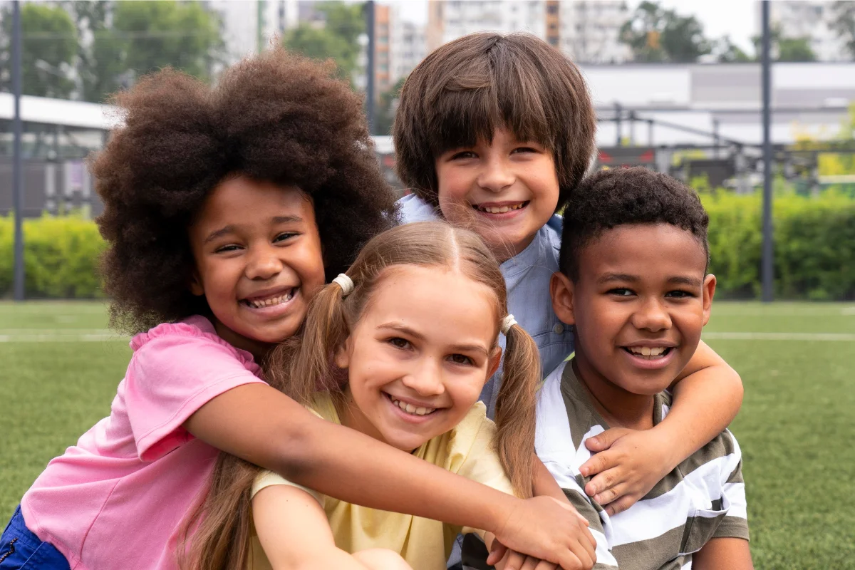 Four smiling children at a pediatric dental clinic in South Florida